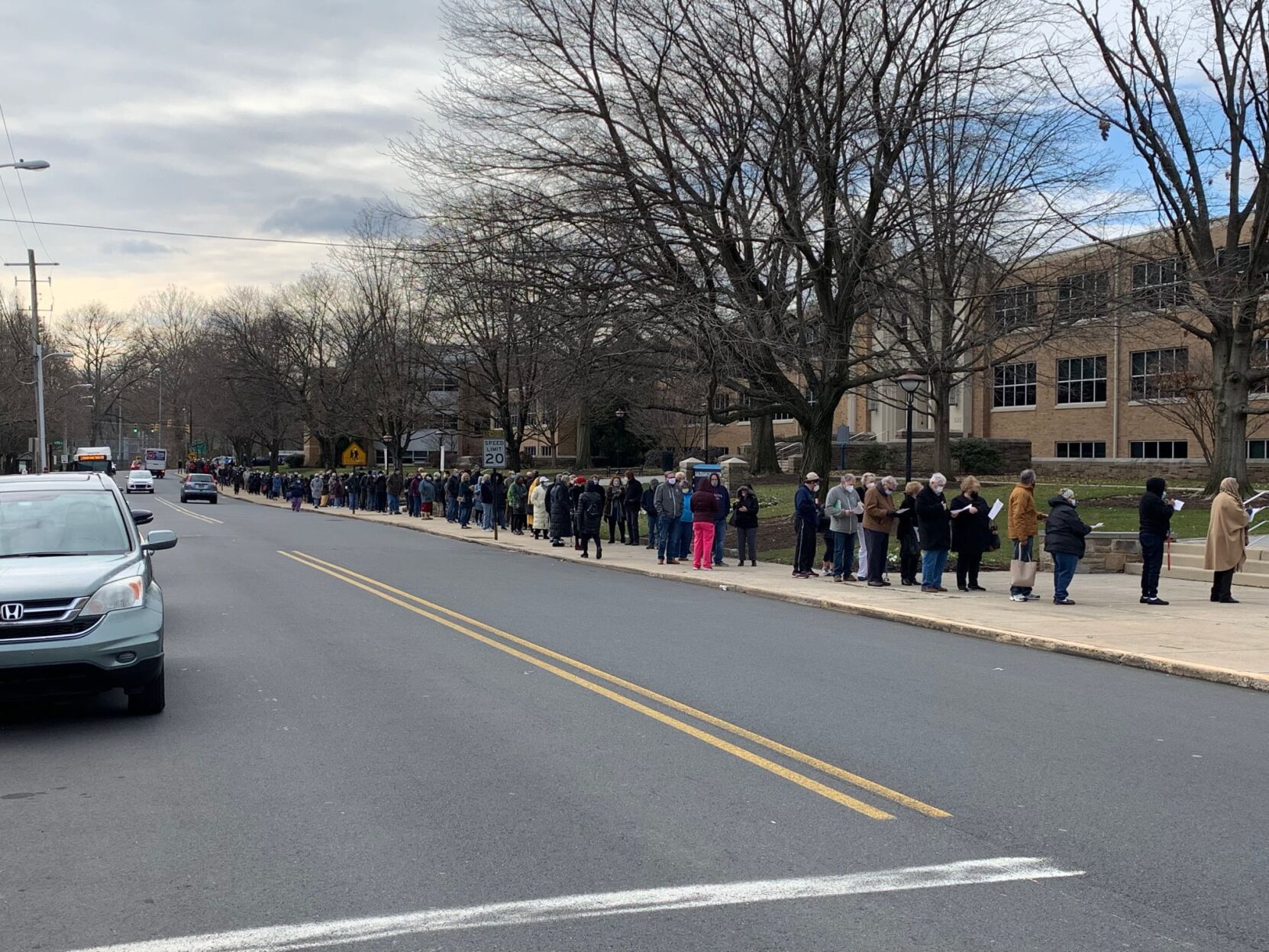 A line forms for a COVID-19 vaccination clinic at Salesianum